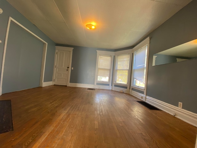 unfurnished living room with hardwood / wood-style floors