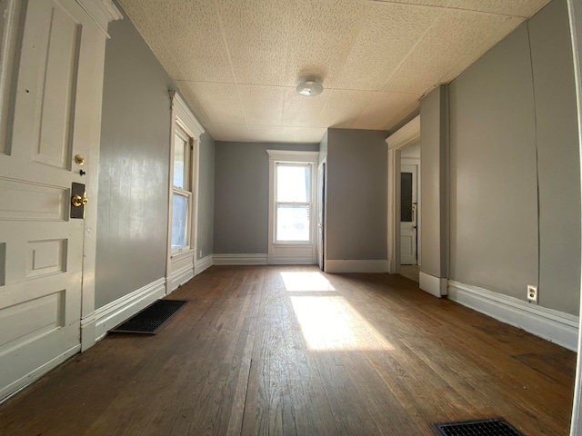 empty room featuring dark hardwood / wood-style flooring