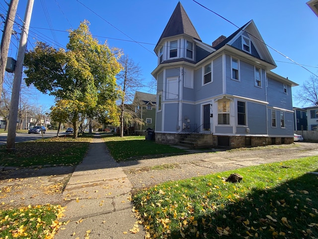 view of side of home featuring a lawn