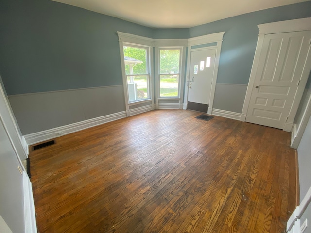 empty room with dark hardwood / wood-style flooring