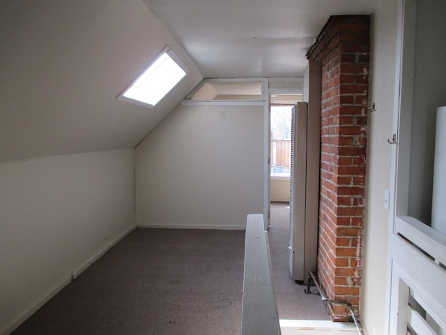 bonus room with carpet flooring and vaulted ceiling