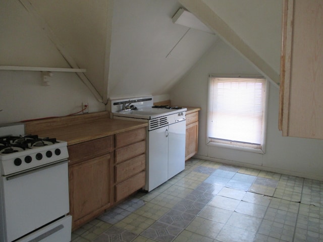 kitchen featuring sink, vaulted ceiling, and white gas range oven