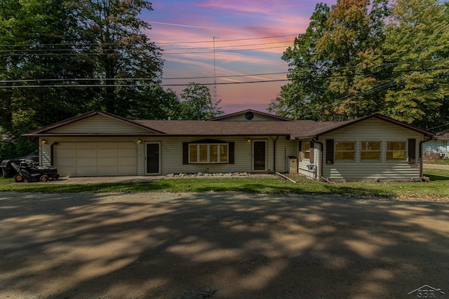 ranch-style home featuring a garage