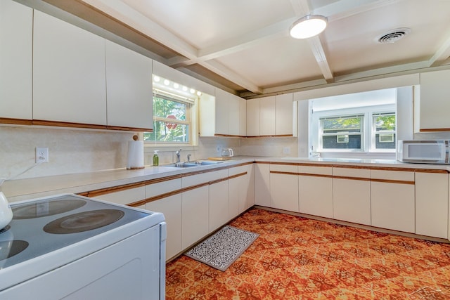 kitchen featuring white appliances, tasteful backsplash, white cabinetry, and sink