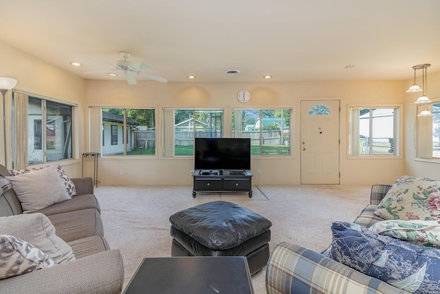 living room with ceiling fan and light colored carpet