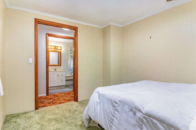 bedroom featuring carpet flooring, ornamental molding, sink, and connected bathroom