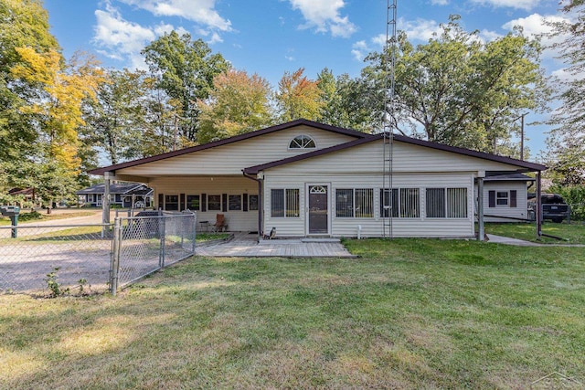 rear view of house featuring a lawn