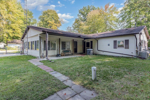 ranch-style home with a front yard, a patio area, and a sunroom