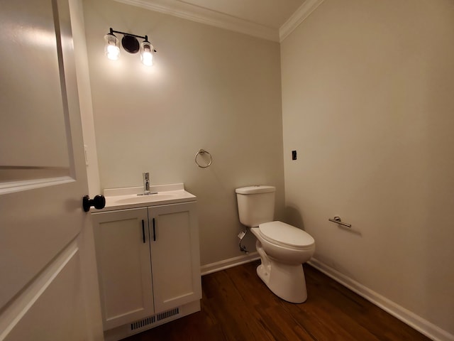 bathroom with vanity, hardwood / wood-style flooring, toilet, and ornamental molding