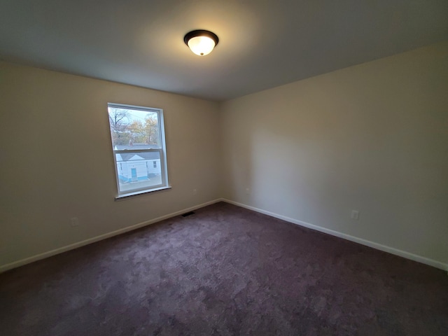 empty room with dark carpet