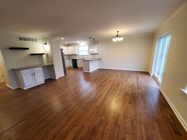 unfurnished living room with a notable chandelier, dark hardwood / wood-style floors, ornamental molding, and sink