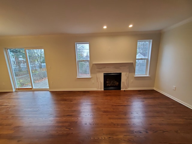 unfurnished living room with dark hardwood / wood-style floors and crown molding