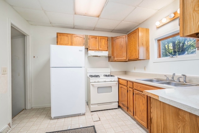 kitchen with white appliances, a paneled ceiling, and sink