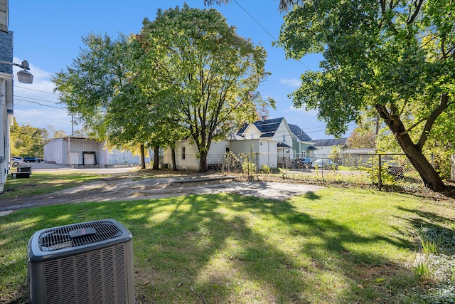 view of front of property with cooling unit, a garage, and a front lawn