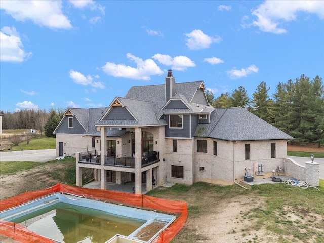 rear view of house with a balcony and central AC