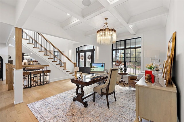 office featuring beamed ceiling, coffered ceiling, and light hardwood / wood-style flooring