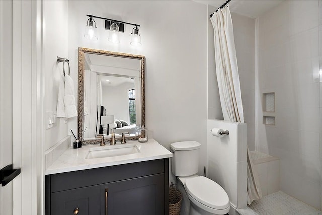 bathroom featuring vanity, toilet, and walk in shower