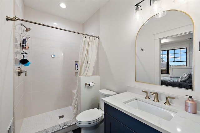 bathroom with vanity, toilet, and walk in shower