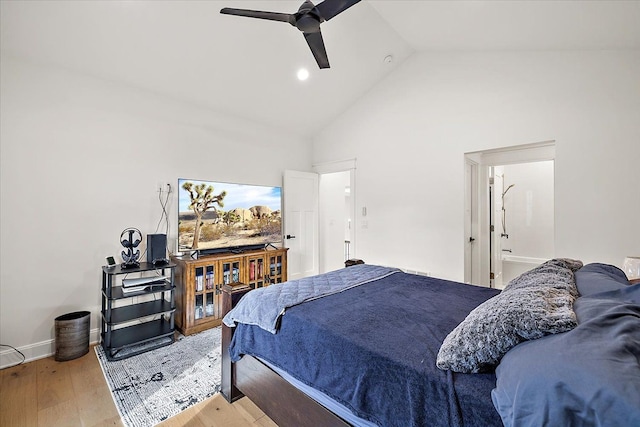 bedroom featuring ensuite bath, hardwood / wood-style flooring, high vaulted ceiling, and ceiling fan