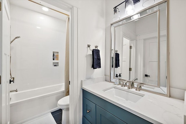 full bathroom with tile patterned flooring, tiled shower / bath combo, toilet, and vanity