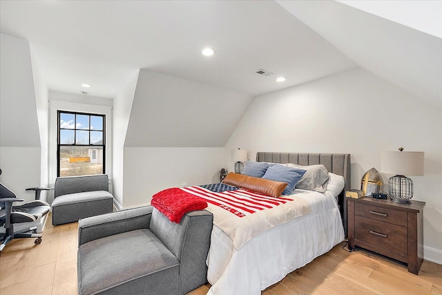 bedroom with light hardwood / wood-style flooring and lofted ceiling