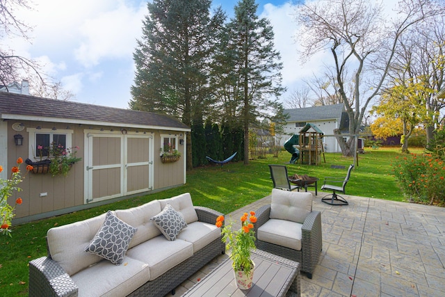 view of patio / terrace featuring a playground, an outdoor living space, and a storage unit