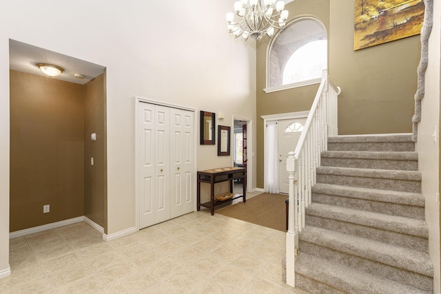 entryway with a towering ceiling and an inviting chandelier