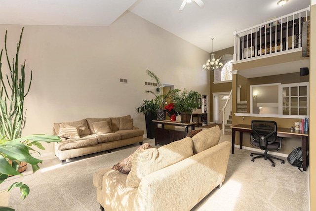 carpeted living room featuring an inviting chandelier and high vaulted ceiling