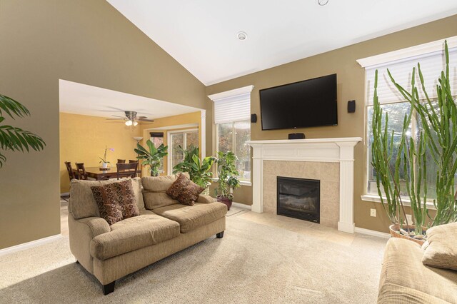 230 E Elizabeth St, Lake Orion, MI 48362 - carpeted living area featuring a tiled fireplace, a ceiling fan, and high vaulted ceiling