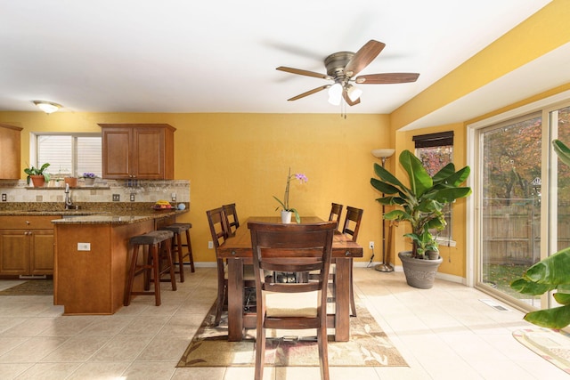 dining room with ceiling fan and light tile patterned floors