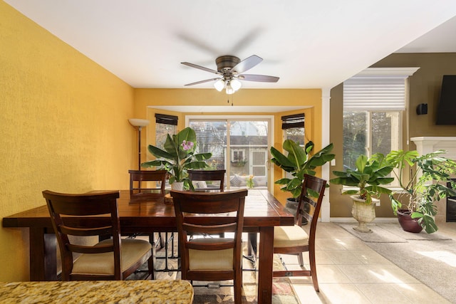 tiled dining area with ceiling fan