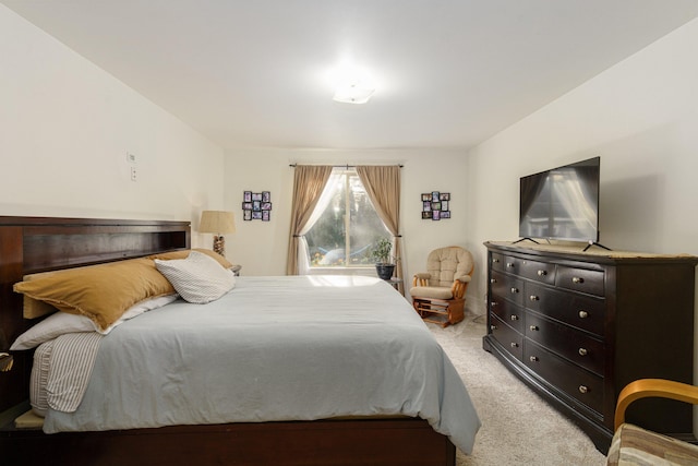 bedroom featuring light colored carpet