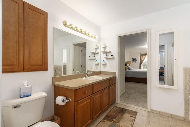 bathroom featuring tile patterned flooring, vanity, and toilet