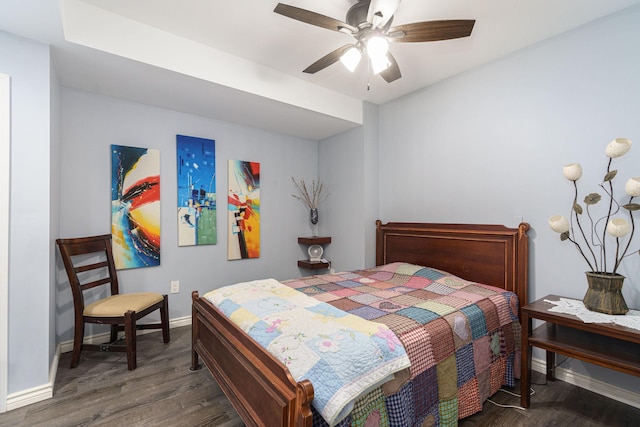 bedroom with ceiling fan and dark hardwood / wood-style floors