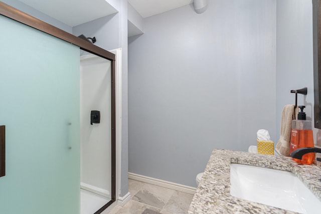 bathroom featuring vanity, toilet, and walk in shower