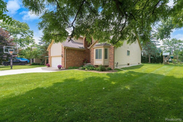 230 E Elizabeth St, Lake Orion, MI 48362 - view of front of property featuring a playground, a front lawn, concrete driveway, and brick siding