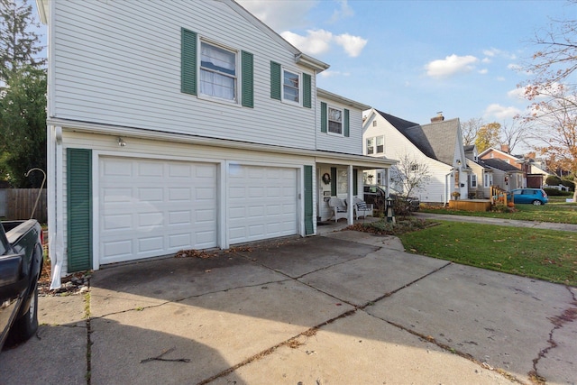 view of property featuring a porch and a garage