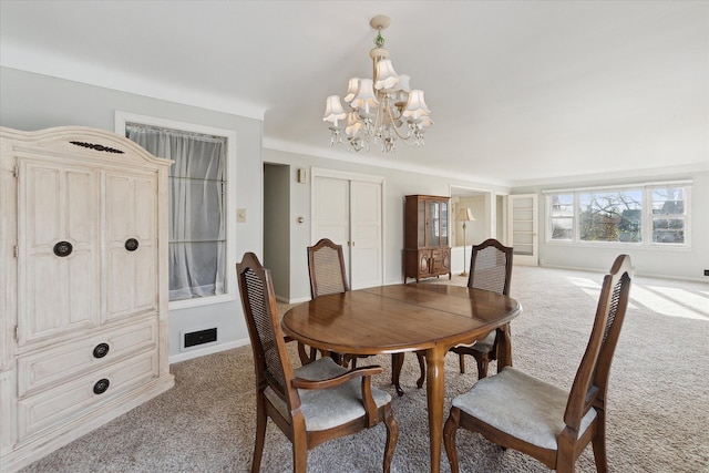 carpeted dining area with a notable chandelier