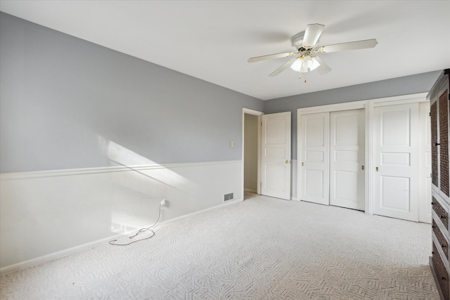 unfurnished bedroom featuring light colored carpet and ceiling fan