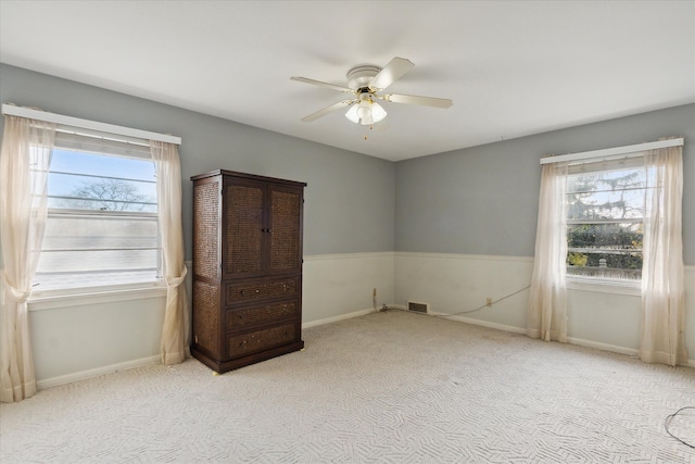 unfurnished bedroom with ceiling fan and light carpet