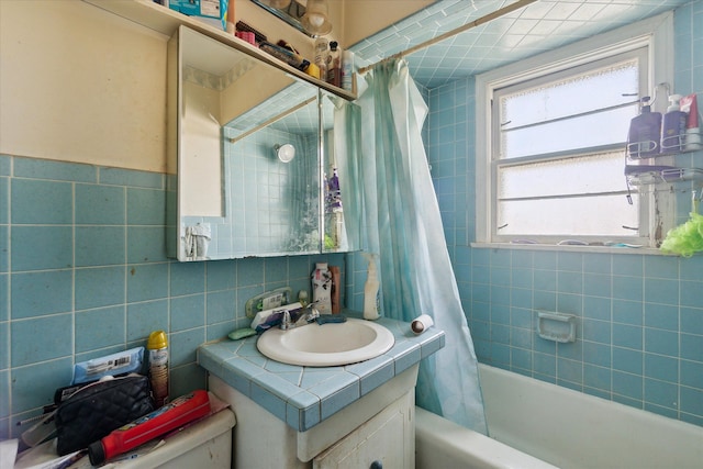 full bathroom featuring shower / bath combo with shower curtain, vanity, tile walls, and toilet