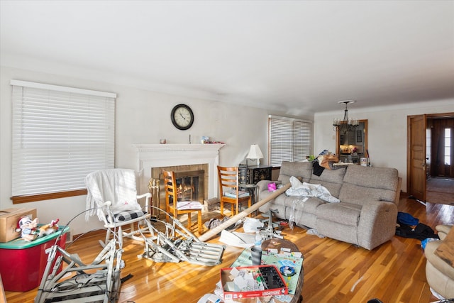 living room with an inviting chandelier and hardwood / wood-style flooring