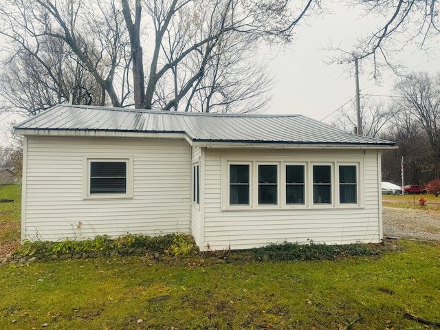 view of property exterior with a yard