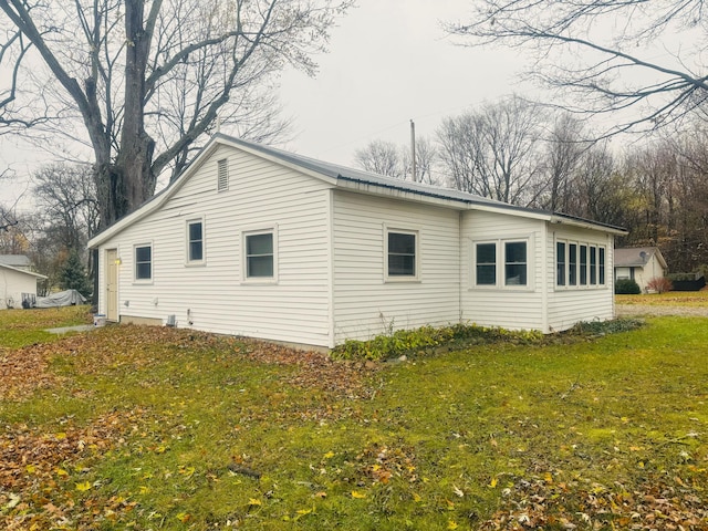 view of side of home featuring a yard