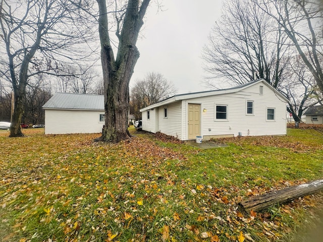 view of property exterior featuring a lawn