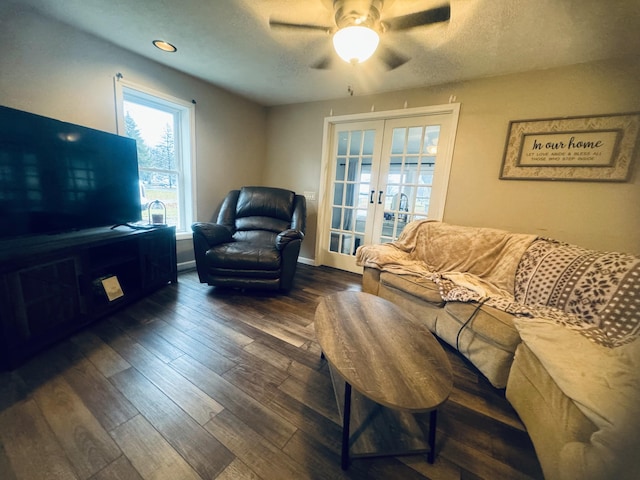 living room featuring dark hardwood / wood-style floors, french doors, and ceiling fan