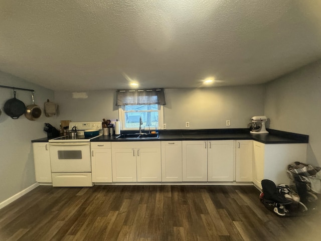 kitchen featuring sink, white electric range, dark wood-type flooring, white cabinetry, and a textured ceiling