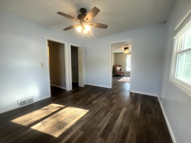 unfurnished bedroom with dark hardwood / wood-style floors and ceiling fan