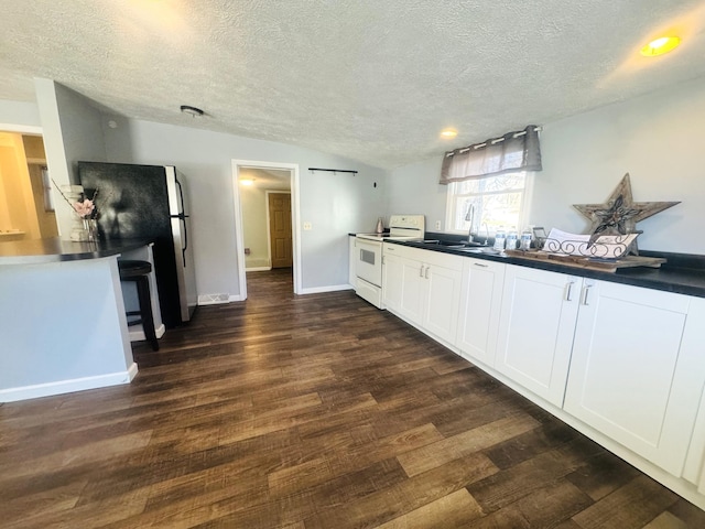 kitchen featuring electric stove, sink, black refrigerator, dark hardwood / wood-style floors, and white cabinets