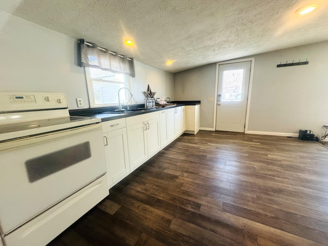 kitchen featuring dark hardwood / wood-style floors, a wealth of natural light, white cabinetry, sink, and electric range